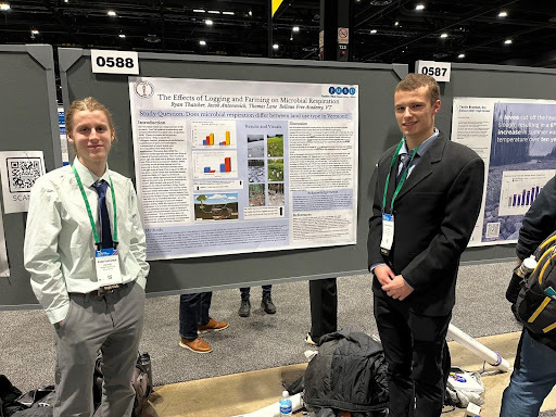 Ryan Thatcher and Jacob Antonovich stand at their poster ready to talk about their research at AGU 2022, Chicago, IL.