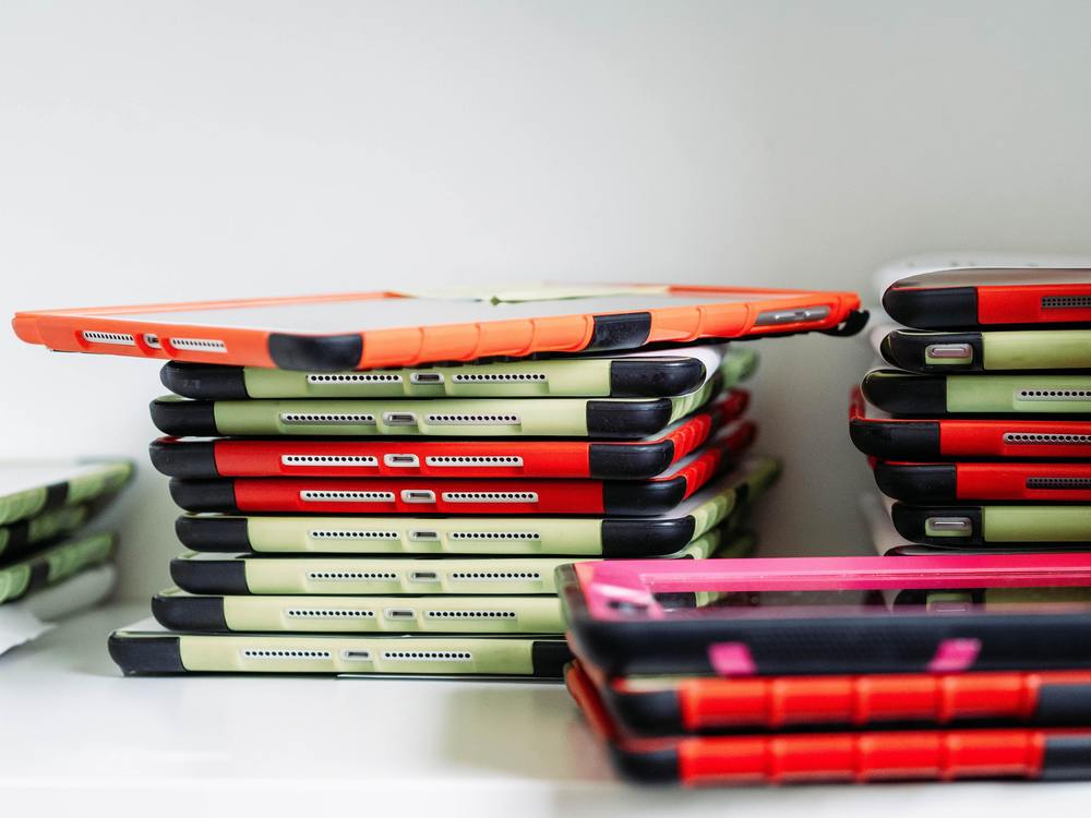 Stacks of classrooms iPads with multi-color cases